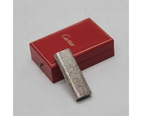 A Cartier silver cased pocket cigarette lighter, having all-over engraved decoration, signed Cartier Paris to the underside a