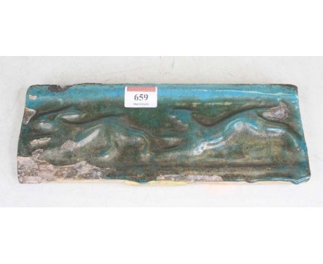 A turquoise glazed wall tile, relief decorated with animals, possibly Syrian, 11 x 26.5cm 