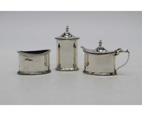 An Elizabeth II silver part condiment set, comprising a mustard pot, open salt, and a pepper, Birmingham 1992, weighable silv