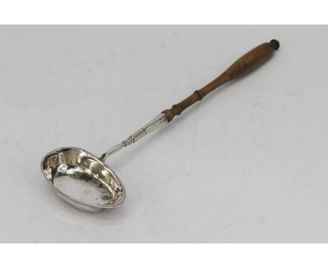A continental silver toddy ladle, having an oval shaped bowl and turned wooden handle, length 37cm