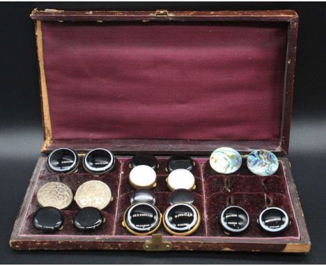 A late Victorian fitted leather case containing assorted pairs of buttons, to include banded agate, silver and mother-of-pear