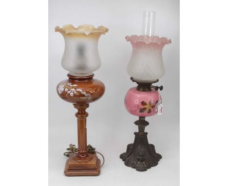 A Victorian oil lamp, having a pink tinted shade above a pink glass hand-painted font upon cast iron base, h.55cm; together w