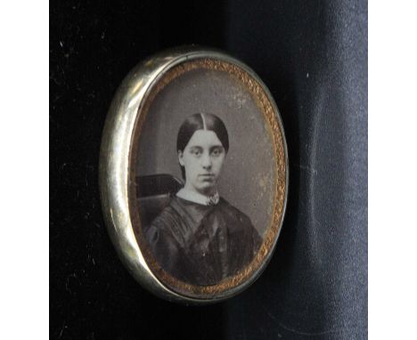 A Victorian mourning pendant, the obverse with photographic portrait of a young woman, the reverse with plaited lock of hair,