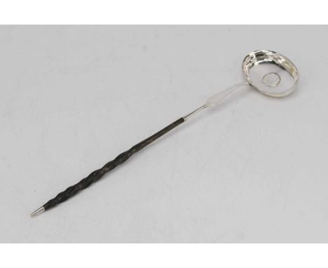 An early 19th century silver toddy ladle, the bowl inset with a coin, having a spiral whalebone handle, length 36cm 