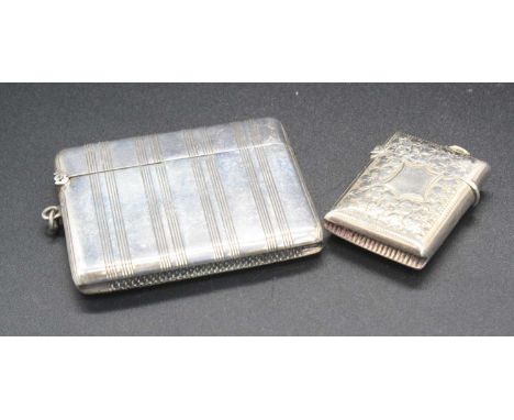 A silver pocket vesta case with banded decoration, width 6cm, together with one other having leaf engraved decoration (2)