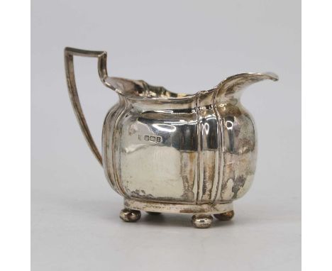 A George V silver cream jug, of reeded form, on bun feet, Sheffield 1911, 6.8oztSlightly wobbly where one foot has worn more 
