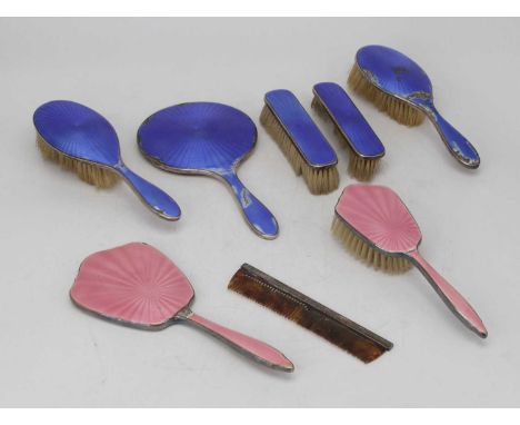 A collection of seven enamel decorated silver dressing table hand brushes and mirrors