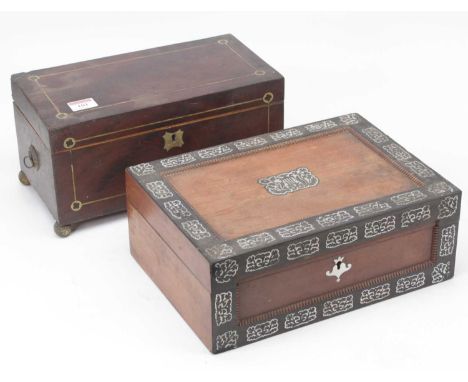 A Regency mahogany and cut brass inlaid tea caddy of typical rectangular form, flanked by brass handles, twin compartment int