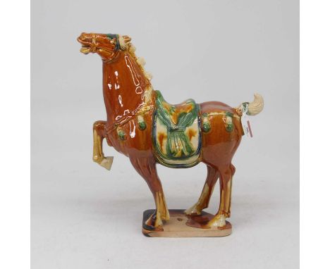 A Chinese sancai glazed model of a tang horse, height 34cm, together with a ceramic plaque decorated with a woodland scene, s