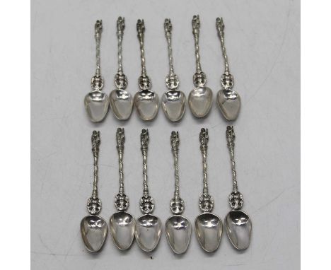 A set of twelve continental silver apostle spoons, each surmounted with a figure and having spiral handle, gross weight 5.9oz