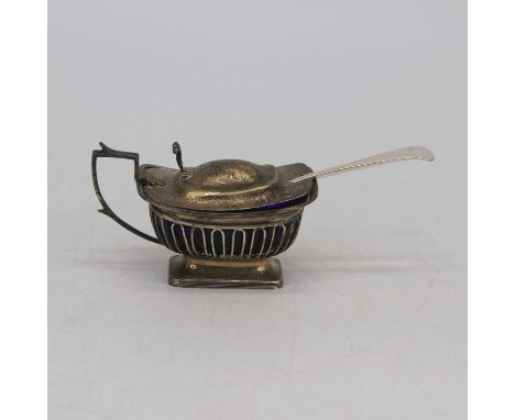 A George V silver mustard, of pierced form, having a hinged lid with scrolled thumbpiece, blue glass liner, silver weight 4oz