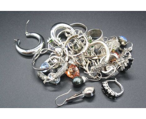 A collection of modern silver and white metal costume jewellery, principally being earrings, and some being semi precious and