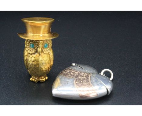 A silver heart-shaped and engraved pocket vesta with gold plated band, together with gilt metal novelty vesta in the form of 