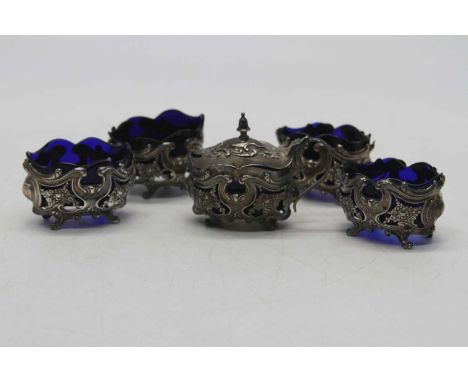 A Victorian silver part condiment set, comprising mustard pot and four open salts, each having pierced floral decorated body 