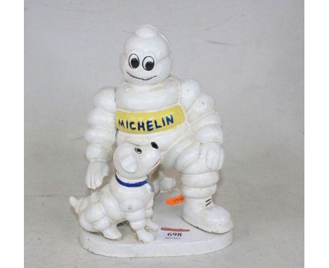 A reproduction cast iron model of the Michelin Man and his dog, h.20cm
