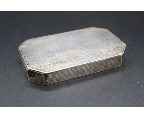 A George V engine turned silver table snuff box of rectangular form with canted corners, gilt washed interior, maker S &amp; 