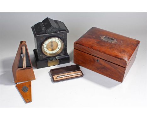 Mixed works of art, to include a box, a metronome, pen and a black slate mantel clock, (4)