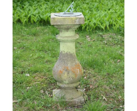 A weathered stone and copper sundial, height 84cm, width 30cm