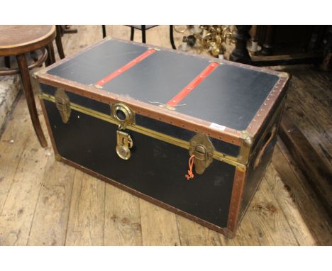 A vintage shipping trunk with brass fittings