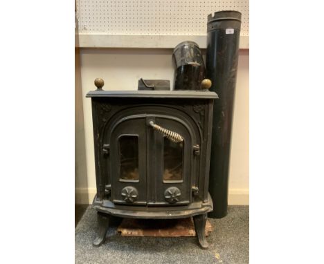 A cast iron log burner, ornate shaped rectangular body, brass finial top, two hinged front doors, 68cm high x 56cm wide  x 47
