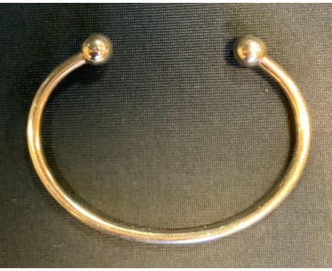 A 9ct gold bangle. 18.5g, boxed 