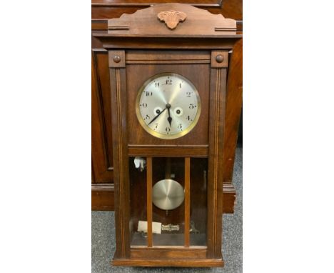 A 20th century oak wall clock, 73cm long. 