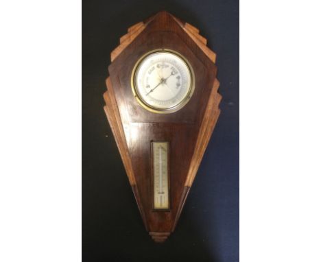 An Art Deco style oak aneroid barometer thermometer, silvered scales, 55cm high, 28cm wide. 