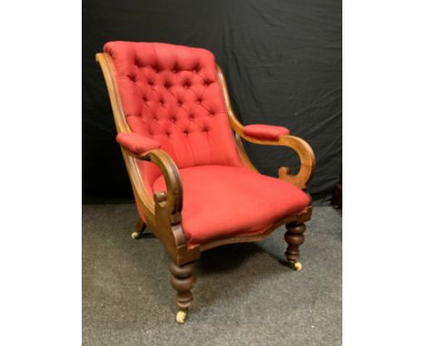 A late  Victorian fireside arm chair, button back, scrolled arms, turned legs, ceramic casters, c1890 
