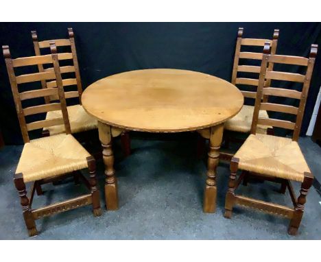 A Rupert Griffith type Arts and Craft style oak dining table, pegged circular top, turned legs, 72cm high, 106cm diameter; a 