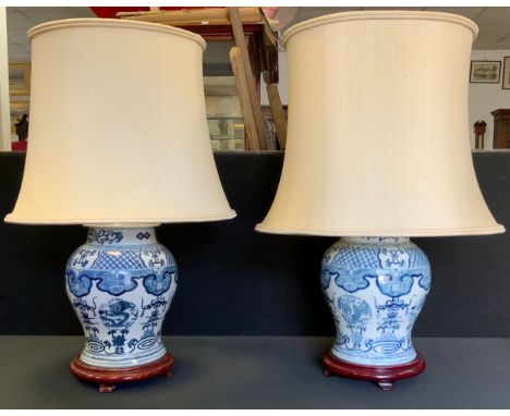 A pair of reproduction Chinese blue and white ginger jar light fittings, , 44cm high, cream shades 