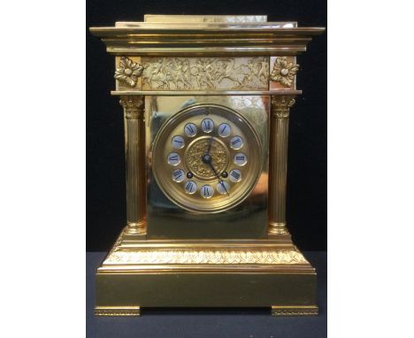 A 20th century brass mantel clock, Roman numerals, flanked by reeded columns, bracket feet. 31cm high, 24cm wide. 