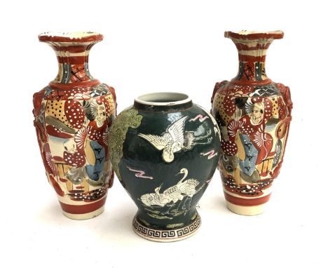 A pair of Japanese vases, 31.5cmH; together with one other depicting storks, with hole drilled for lamp conversion, 22.5cmH 
