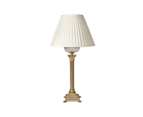 A gilt brass and glass oil lamp, late 19th century, with cut glass reservoir now fitted with for electricty, base with fitmen