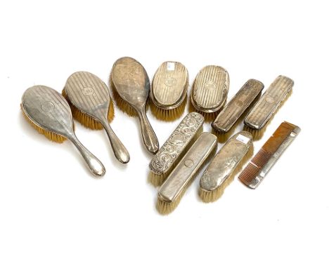 A mixed lot of early 20th century silver backed clothes and hair brushes, with a comb (11) 