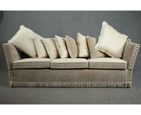 A Knole sofa, fully re-upholstered and covered with a matching set of cushions. H.80 W.250 D.75cm. 