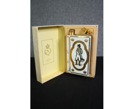 A boxed porcelain flask by Limoges containing Camus Cognac Napoleon brandy. H.25 W.16 D.8cm. 