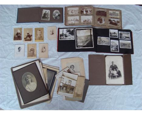 A collection of early 20th Century and later photograph albums and black and white portrait photographs. 