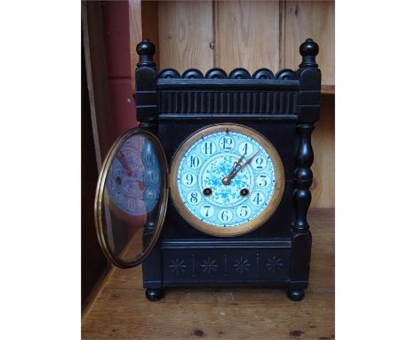 A cased eight day mantle clock, with (cracked) blue enamel dial and Arabic numerals, with key. 