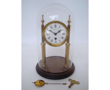 An early 20th Century French gilt brass Portico clock, the circular white enamel dial with Roman numerals, on fluted column s