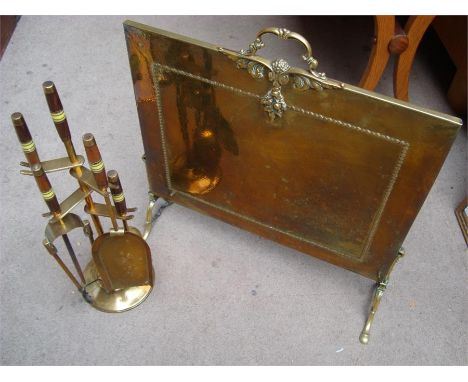 A fire guard together with a set of fire tools. 