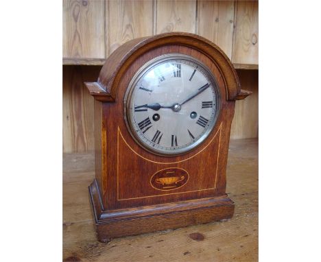 An eight day mantle clock, with Roman numerals and the case inlaid with marquetry, with key.