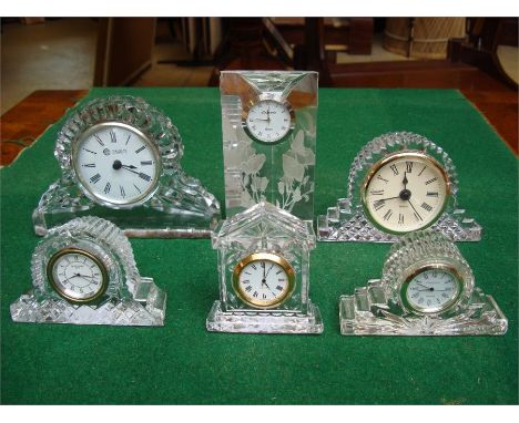 A Waterford crystal mantle clock together with a Galway Irish crystal mantle clock, a 'One World' quartz clock, a Leonardo cl