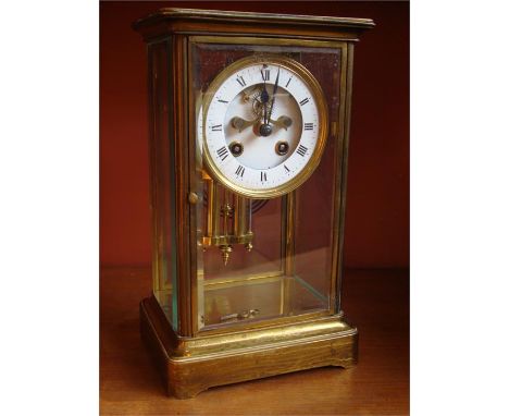 A 19th Century French brass four glass mantle clock, with white enamelled dial and Roman numerals, blue steel hands and expos