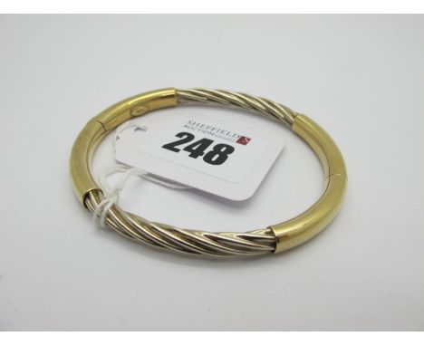 A Modern Hinged Bangle, of part twisted design, (sprung hinge) stamped "375" (overall weight 14.5grams). 
