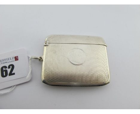 A Hallmarked Silver Vesta Case, WN Ltd, Birmingham 1922, of slim cushion shape allover engine turned, with suspension loop (3