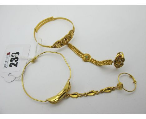 An Indian Expanding Bangle, with colour highlights, with ring on attached chain (bangle stamped "22C"); Together with Another