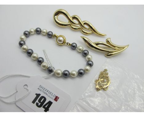 A Dainty Pendant, on a fine chain stamped "375"; two modern gold plated brooches and an imitation pearl bead bracelet. 