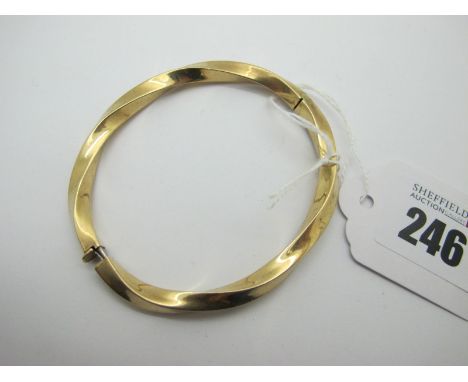 A Modern Hinged Bangle, of twisted design, hinged to snap clasp (stamped "9ct" (11.5grams). 