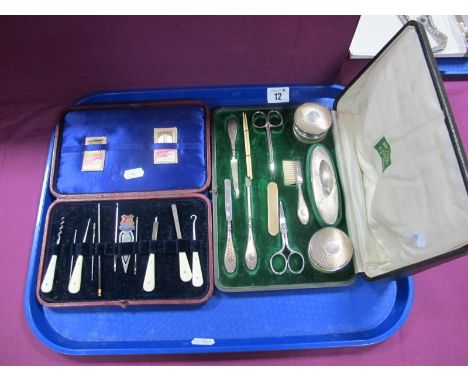 A Vintage Cased Manicure Set, including hallmarked silver topped jars, handled marked silver handled implements, two pairs of