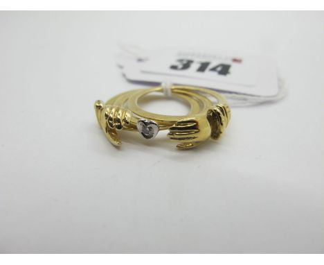 A 9ct Gold Gimmel Ring, of antique style, as two clasped hands, swiveling to reveal heart with inset highlight (finger size K